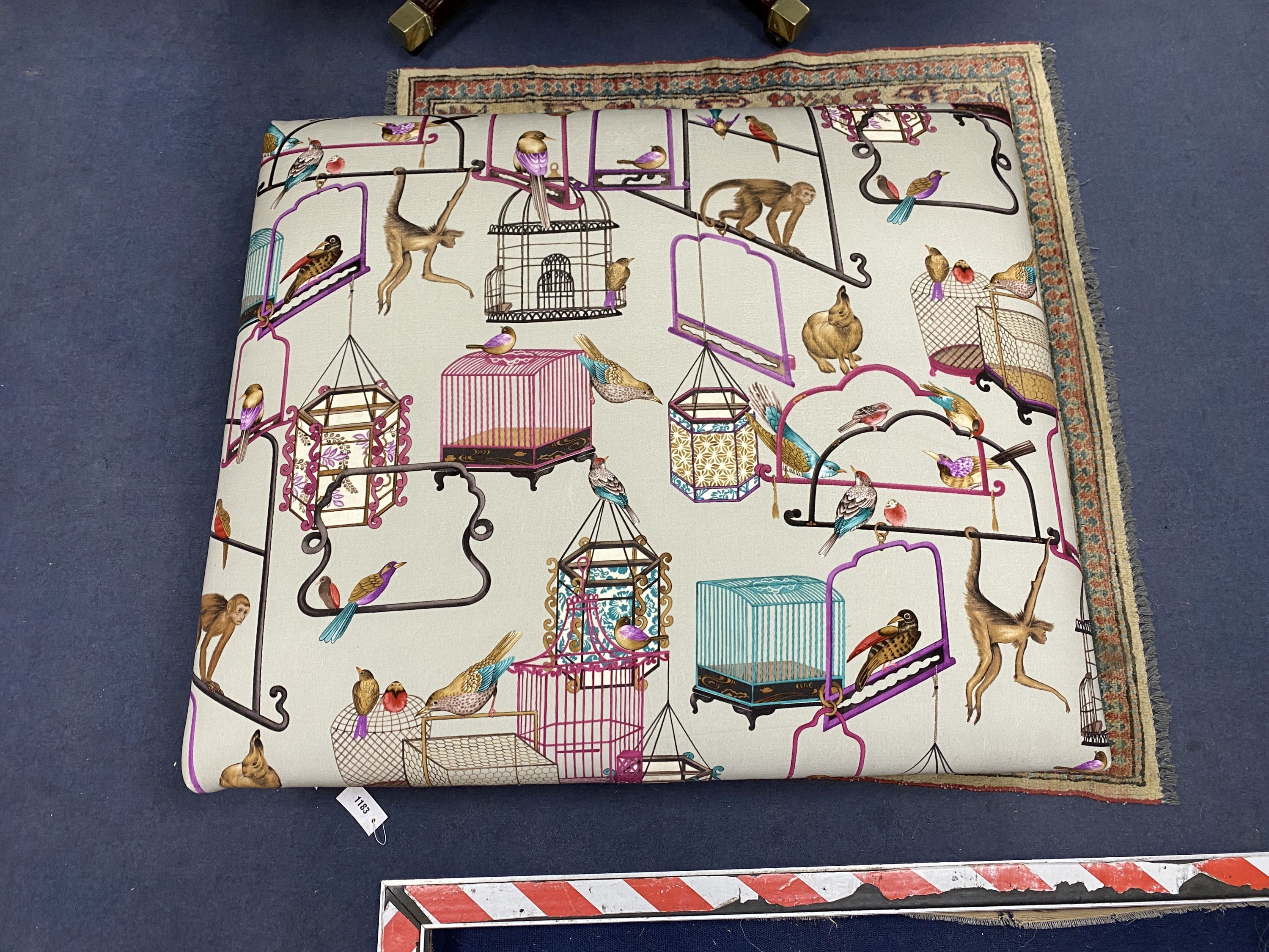 A Victorian-style rectangular footstool, upholstered in menagerie fabric, width 106cm, height 90cm
